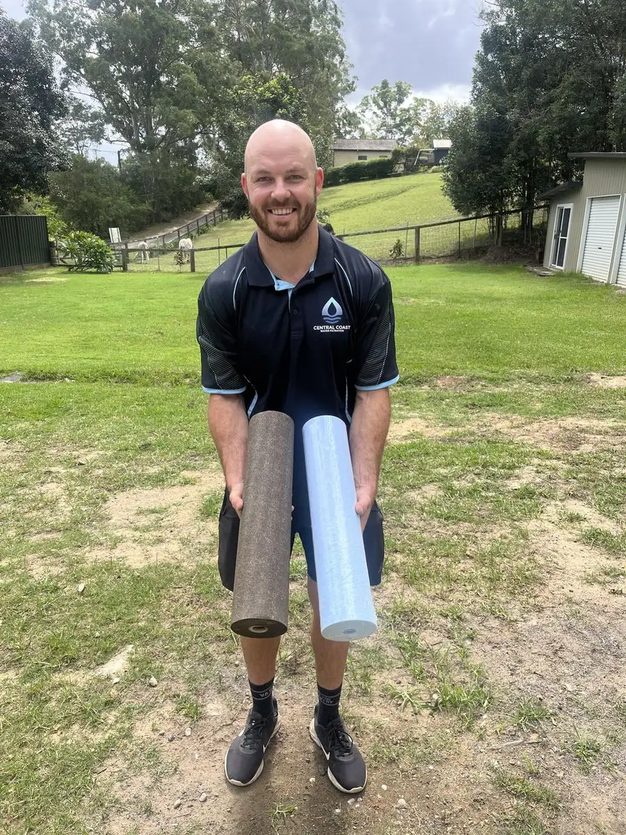 Adam, owner of Central Coast Water Filtration, holding filter cartridges