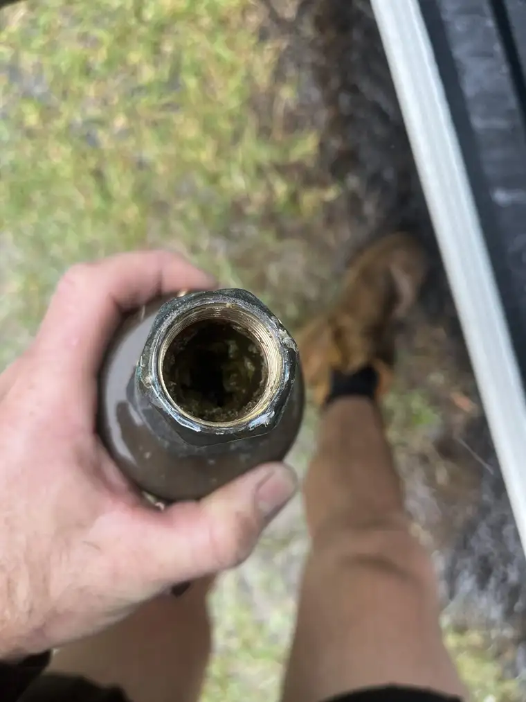 Another customer's inlet pipe showing thick sediment and mineral build-up restricting the water flow